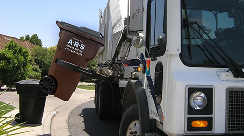 Trash pickup truck servicing carts